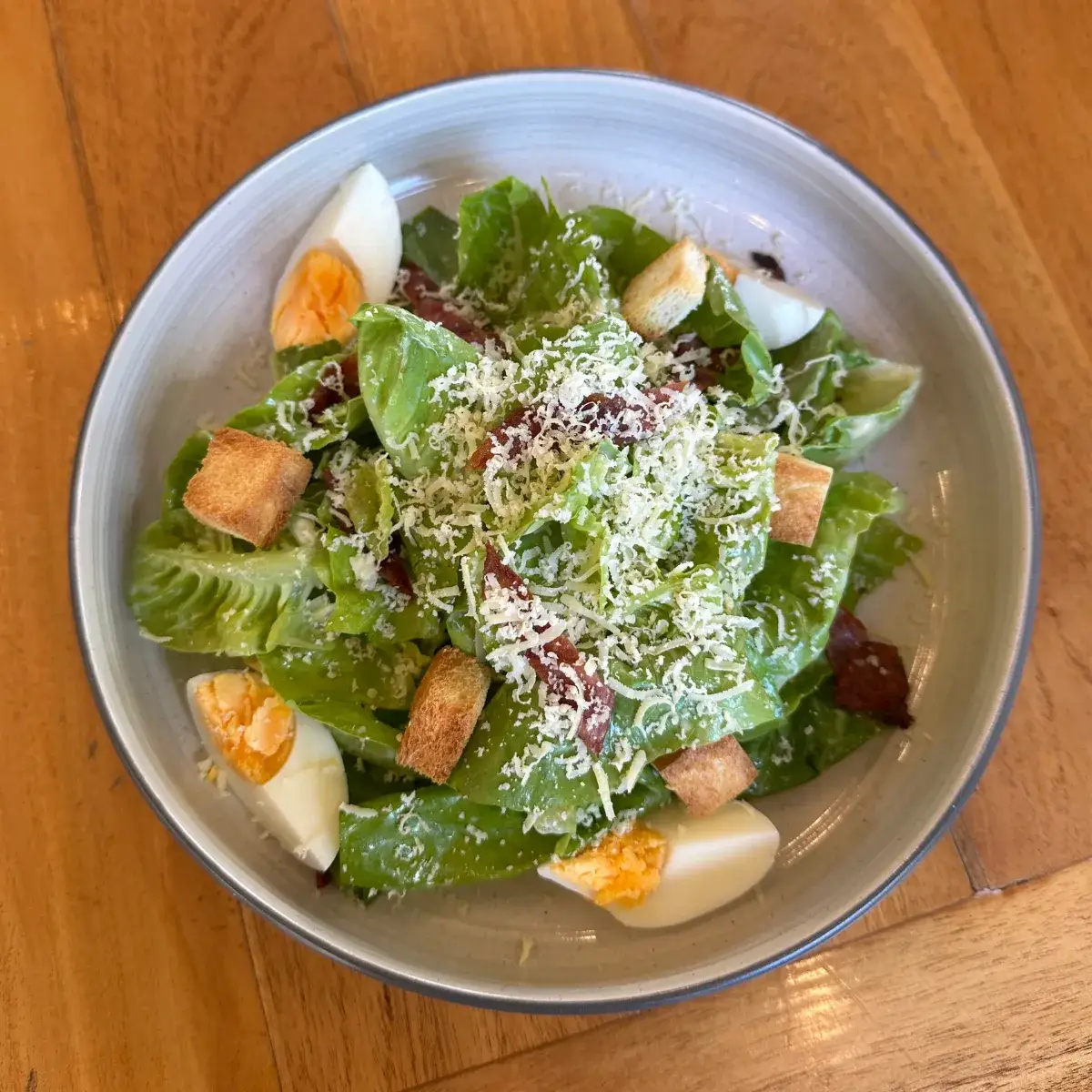 A fresh Caesar salad with grilled chicken and shaved parmesan