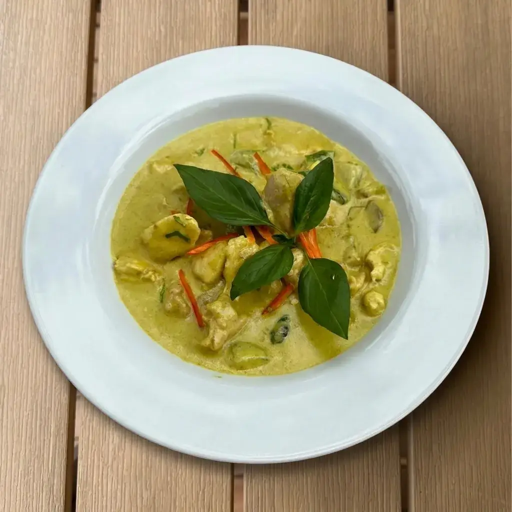 Chicken green curry in coconut milk with Thai herbs, served with steamed rice at Thongyib Thongyod