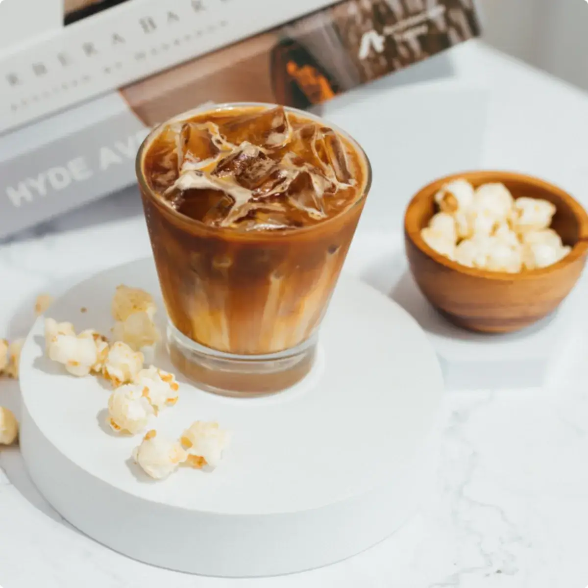 Popular Coffee — iced caramel popcorn coffee served with a bowl of popcorn