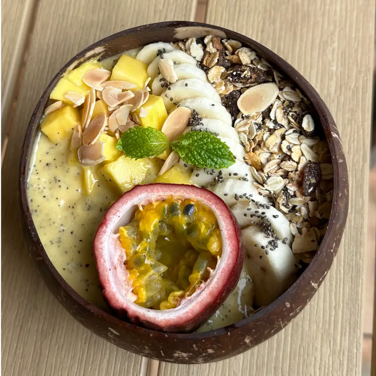 Tropical Paradise smoothie bowl topped with fresh mango, dragon fruit and granola